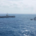 US aircraft carrier patrols contested South China Sea, shadowed by Chinese warships